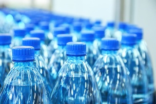 Closeup on mineral water green bottles in raw and lines