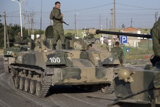 Russian soldiers on tracked armored vehicles in front of the railway crossing about 30 kilometers from the border with Ukraine.