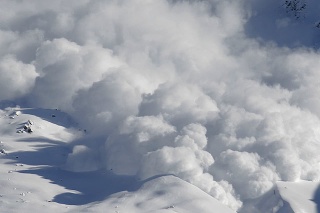 Dry snow avalanche with a powder cloud close to the village Terskol, Elbrus region