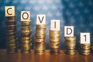 Diminishing stacks of coins with COVID-19 (Coronavirus disease) written on them