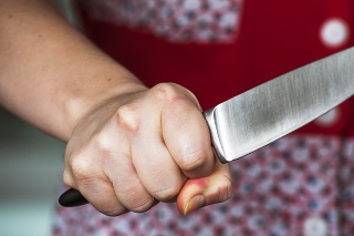 Woman hand holding big knife. Aggressive woman.