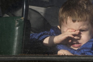 Chlapec čakajúci na evakuáciu do Ruska sa pozerá cez okno autobusu v Donecku, na území kontrolovanom proruskými militantmi, východná Ukrajina, sobota 19. februára 2022