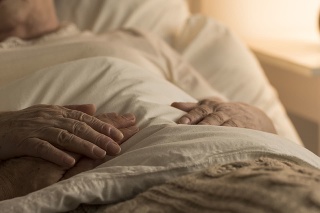 Close-up of hand of senior on hand of dying elderly person as sign of support during sickness