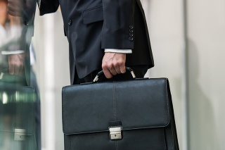 Leather briefcase held by a man.