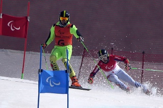 Slovenský reprezentant v paraalpskom lyžovaní Miroslav Haraus (vpravo) a navádzač Maroš Hudík počas obrovského slalomu zrakovo znevýhodnených na zimných paralympijských hrách v Pekingu.
