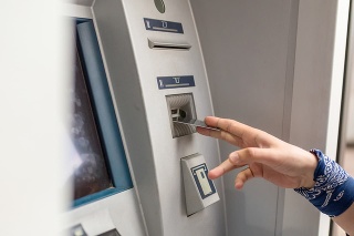 Man using his credit card in an atm for cash withdrawal