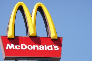 Ljubljana, Slovenia - September 3, 2011: Close-up of McDonalds outdoor sign with  typical rounded yellow M letter against cloudless blue sky. Sign is positioned on the left side of image.