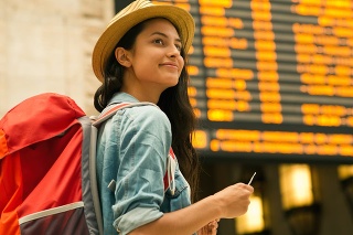 Young woman checking her train in time board