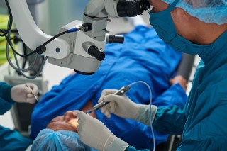 Doctor performing eye surgery in modern clinic