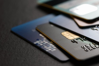stack of multicolored credit cards on black background