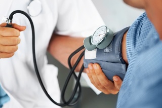 A doctor listening to his patient's heartbeat with a stethoscope