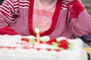 Real life photos of 106-year-old centenarian woman celebrating her birthday with a tired look on her face.