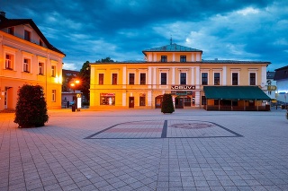 Dolny Kubin, Slovakia - May 31, 2016: Main square of Dolny Kubin late in the evening. There is a coat of arms in the cobble stone of the square.