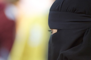 Portrait of a middle eastern woman wearing a black Niqab.