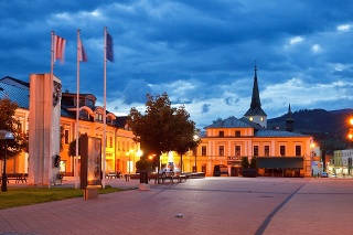 Dolny Kubin, Slovakia - May 31, 2016: Main square of Dolny Kubin late in the evening. Old Gothic church can be seen in the distance behind the building.