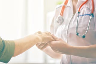 Female patient listening to doctor in medical office.