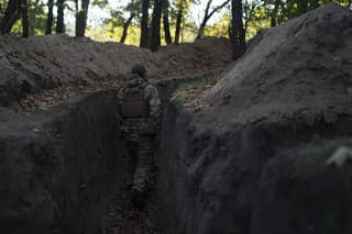 Na archívnej snímke z 12. októbra 2022 ukrajinský vojak kontroluje zákopy, ktoré vykopali ruskí vojaci na dobytom území v Chersonskej oblasti na juhu Ukrajiny.