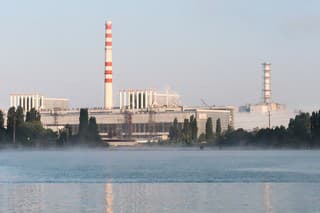 Kursk Nuclear Power Plant reflected in a calm water surface. Mist over the water.