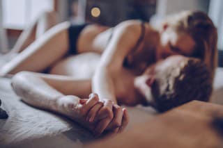 Couple cuddling in the bedroom