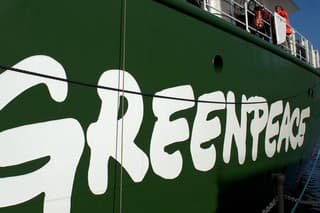 London, United Kingdom - November 13 2011: Rainbow Warrior III name and logo on side of Greenpeace's ship with members of the public visiting it on its open day in London.
