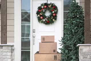 front door with christmas wreath and packages