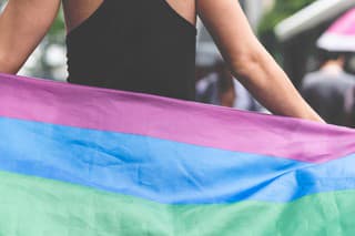 Confident Gay Man Holding Rainbow Flag