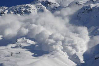 Dry snow avalanche with a powder cloud close to the village Terskol, Elbrus region