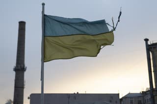A weathered Ukrainian flag flies in the Podil district of Kyiv, Ukraine