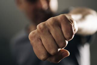 closeup of a young caucasian man throwing a punch to the observer, with a dramatic effect