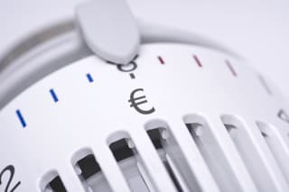 Thermostat of an heating radiator with Euro symbol, rising costs for heat and energy concept.