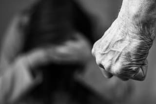 Domestic violence man against woman clenched fist black and white image