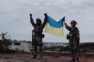Ukrainian military holds the flag of Ukraine. The concept of victory. The war between Ukraine and Russia.