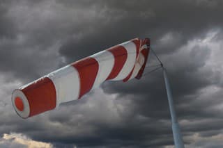 Attention storm warning! Windsock in front of an approaching thunderstorm front.