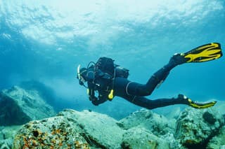 Scuba diving. Beautiful sea. Underwater scene with male scuba diver, enjoy  in blue, shallow water. Scuba diver point of view.