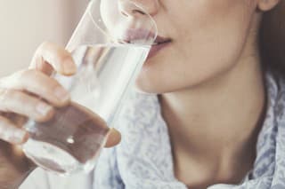 Young woman drinking pure glass of water