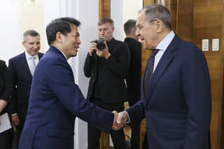 Ruský minister zahraničných vecí  Sergej Lavrov (vpravo) si podáva ruku s osobitným predstaviteľom čínskeho ministerstva zahraničných vecí pre eurázijské záležitosti Li Chuejom.