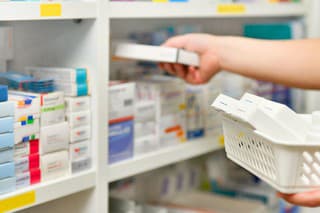 Pharmacist filling prescription in pharmacy drugstore