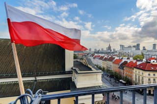 Poland Flag in Blue Sky and the centre of Warsaw in background