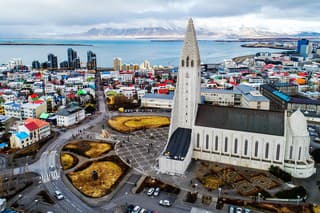 Aerial view of famous Hallgrimskirkja Cathedral and the city of Reykjavik in Iceland. Image taken with action drone camera