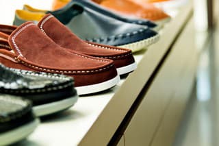 Men's shoes on sale displayed in a store.