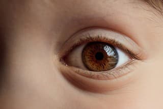 Beautiful big brown eye close-up. Caucasian appearance. Part of a child's body. Dark saturated color. Eyesight check. Macro. Happy childhood. Caring for the health of vision. Good emotion. Happiness.
