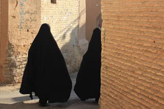 iranian women in black chador on the street