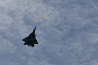Moscow Russia AUGUST, 26, 2015 Dramatic image of the black silhouette of a Russian fighter plane in the sky. Copy space. Sukhoi Su-57 Felon stealth multirole fighter jet airplane of Russian AirForce