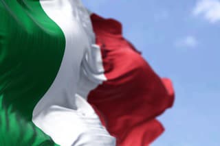 Detail of the national flag of Italy waving in the wind on a clear day. Democracy and politics. European country. Selective focus