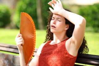 Woman in a park suffering heat stroke