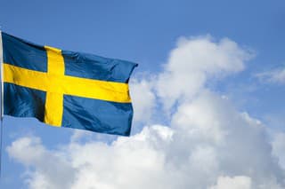 Swedish flag blowing in the wind on a sunny day.