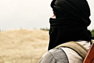 Muslim rebel with automatic rifle and machine-gun belt