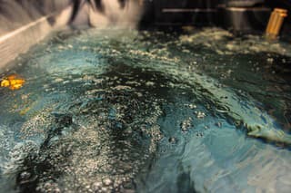 Water in the hot tub, with a water jet, produces bubbling stream for a relaxing massage.