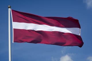 The flag of Latvia waving in the wind.