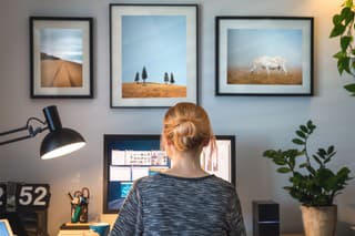 Woman working on computer in her home office during pandemic quarantine.